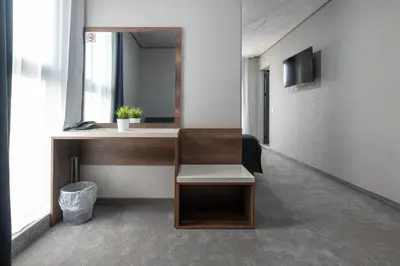 a room with a desk with a mirror and a sink at Hotel Boutique 5 - Free parking - Free breakfast - Free internet - EVSE in Sofia