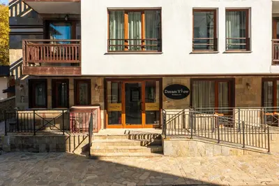 a building with stairs in front of it at Dream View Apartments in Pamporovo