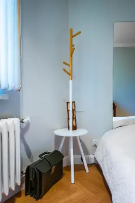 a suitcase sitting on the floor next to a bed at Cozy Heaven at Vitosha Blvd - Sofia - 2BDR in Sofia