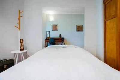 a bedroom with a white bed and a desk at Cozy Heaven at Vitosha Blvd - Sofia - 2BDR in Sofia