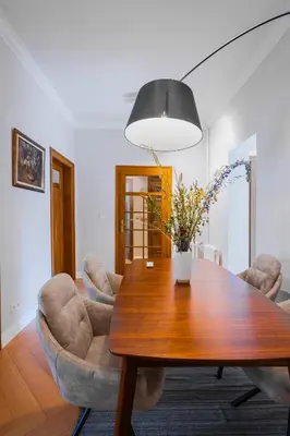 a dining room with a wooden table and chairs at Cozy Heaven at Vitosha Blvd - Sofia - 2BDR in Sofia