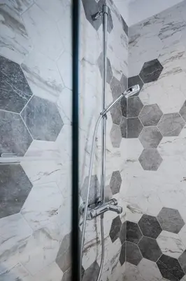 a shower with a glass door in a bathroom at Cozy Heaven at Vitosha Blvd - Sofia - 2BDR in Sofia
