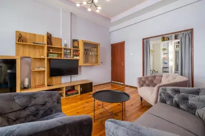 a living room with two couches and a tv at Charming 2BDR Apartment in Historic Center With Parking in Sofia