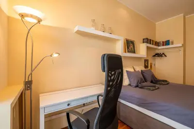 a bedroom with a bed with a desk and a chair at Charming 2BDR Apartment in Historic Center With Parking in Sofia