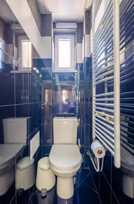a bathroom with a toilet and a sink and a tub at Charming 2BDR Apartment in Historic Center With Parking in Sofia