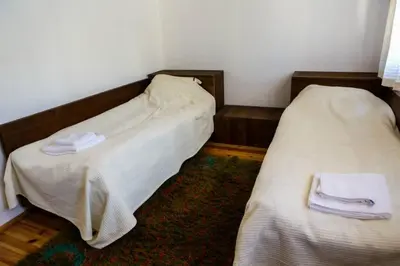 two beds in a room with towels on them at Delchovski Han in Delchevo