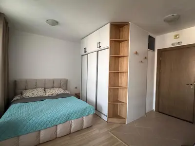 a bedroom with a bed and a book shelf at Bansko Ski Resort Apartment 2-3 people in Bansko