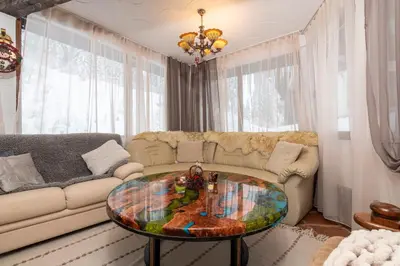 a living room with a couch and a glass table at The Golden Nest - 3 Bedroom Family Mountain Apartment in Pamporovo