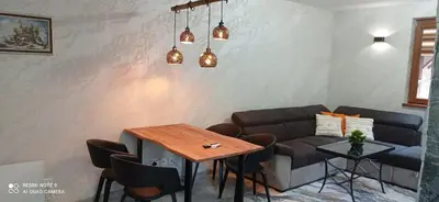 a living room with a couch and a table at АПАРТАМЕНТ WISH in Pamporovo