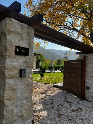 a entrance to a stone building with a wooden gate at Valmont Luxury Chalet in Glozhene