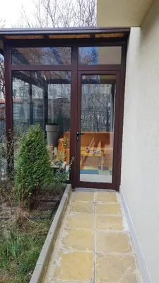 an entrance to a house with a sliding glass door at Cozy apartment with balcony in Sofia