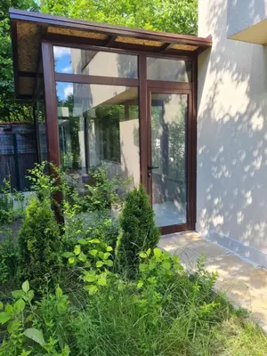 a sliding glass door of a house with plants at Cozy apartment with balcony in Sofia
