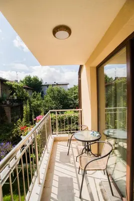 a balcony with a table and chairs and a view at Cozy apartment with balcony in Sofia