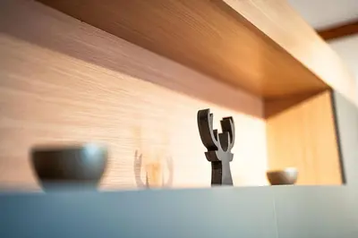 a cross on top of a counter with two cups at Bansko Best View Apartment in Bansko