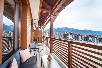 a balcony with a view of a city and mountains at Bansko Best View Apartment in Bansko
