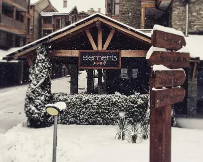 a sign in the snow in front of a building at Bansko Best View Apartment in Bansko