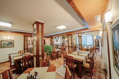 a restaurant with tables and chairs in a room at OAK PARADISE in Smolyan