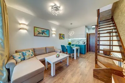 a living room with a couch and a table at OAK PARADISE in Smolyan