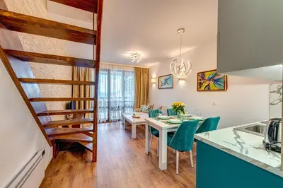 a kitchen and dining room with a table and chairs at OAK PARADISE in Smolyan