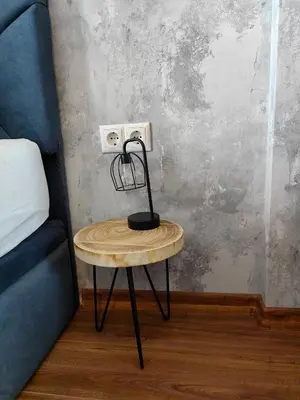 a table with a lamp on it next to a bed at Luxury Apartment/Studio in Plovdiv