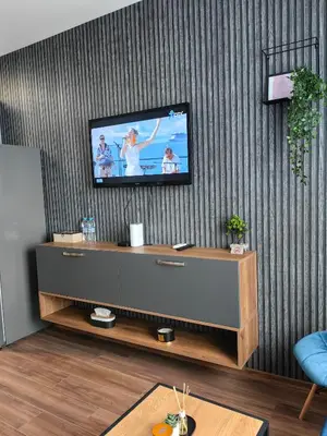 a living room with a flat screen tv on a wall at Luxury Apartment/Studio in Plovdiv