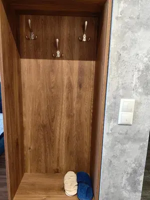 a wooden cabinet with some clothes in it at Luxury Apartment/Studio in Plovdiv
