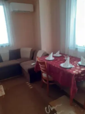 a living room with a table and a couch at Apartment Ceco in Troyan