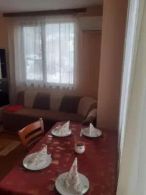 a table with plates of food on top of it at Apartment Ceco in Troyan