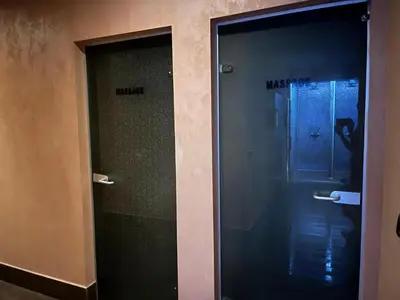 two glass doors in a bathroom with a person in the shower at Charming comfortable apartment at Cornelia Deluxe Residence with free pool and SPA in Razlog