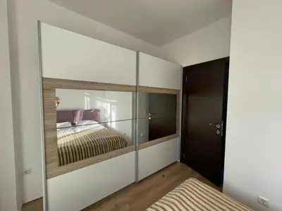 a bedroom with a large mirror in a room at Charming comfortable apartment at Cornelia Deluxe Residence with free pool and SPA in Razlog