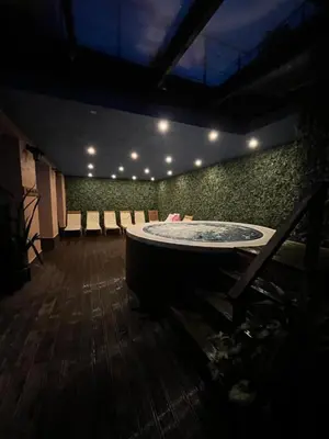 a room with a large tub in the middle of a room at Charming comfortable apartment at Cornelia Deluxe Residence with free pool and SPA in Razlog
