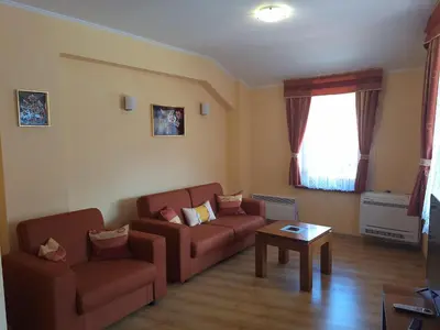 a living room with a couch and a table at SNOW PEAK TODORKA AND VIHREN APARTAMENT /NEXT TO THE LIFT/ 7 PERSONS/ in Bansko