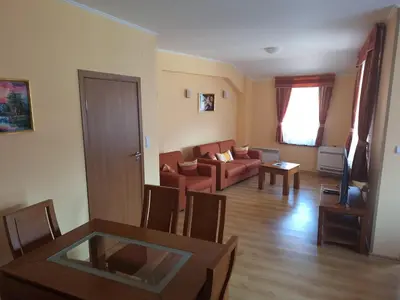 a living room with a couch and a table at SNOW PEAK TODORKA AND VIHREN APARTAMENT /NEXT TO THE LIFT/ 7 PERSONS/ in Bansko