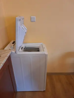 a white washing machine in a corner of a room at SNOW PEAK TODORKA AND VIHREN APARTAMENT /NEXT TO THE LIFT/ 7 PERSONS/ in Bansko