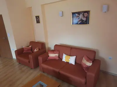 a living room with two brown couches with pillows at SNOW PEAK TODORKA AND VIHREN APARTAMENT /NEXT TO THE LIFT/ 7 PERSONS/ in Bansko