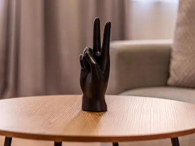 a black hand statue sitting on top of a table at Trocadero Touch: Sofia Hideaway in Sofia