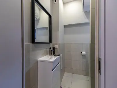 a bathroom with a sink and a mirror at Trocadero Touch: Sofia Hideaway in Sofia