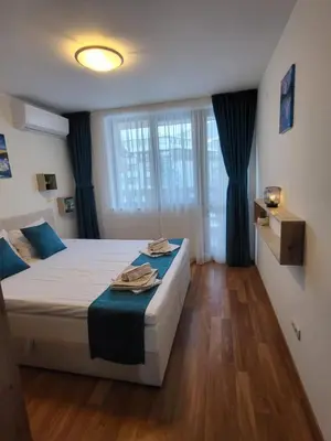 a bedroom with a bed and a large window at Beautiful Apartment in Bansko