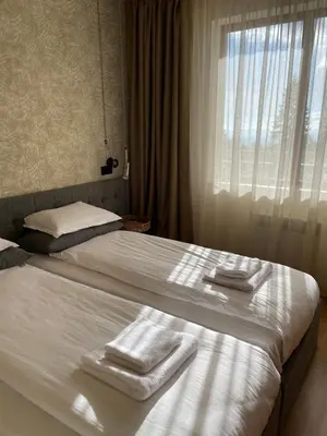 a hotel room with two towels on a bed at LHApartment! in Pamporovo