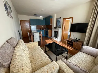 a living room with a couch and a table at LHApartment! in Pamporovo