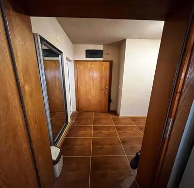 a hallway with a door and a tiled floor at LHApartment! in Pamporovo