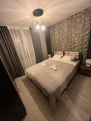 a bedroom with a large bed with towels on it at Royal Park Bansko premium in Bansko