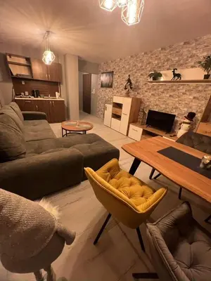 a living room with a couch and a table at Royal Park Bansko premium in Bansko