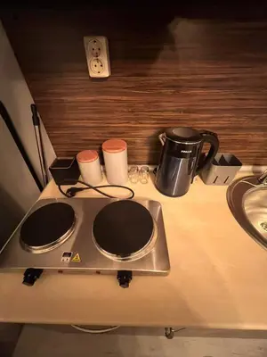 a stove top with two cups on top of it at Royal Park Bansko premium in Bansko