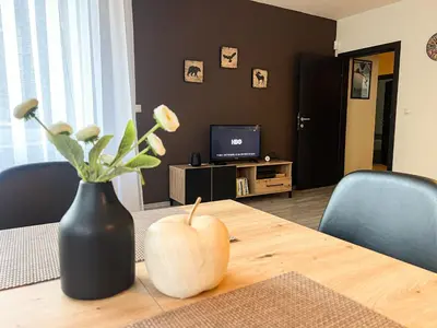 a dining room table with a vase on top of it at Elite Apartments Complex Iglika Borovets in Borovets