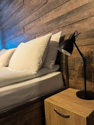 a bedroom with a bed and a desk with a lamp at Elite Apartments Complex Iglika Borovets in Borovets