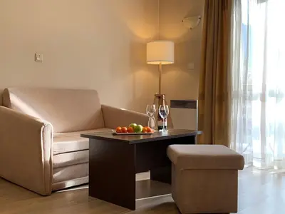 a living room with a couch and a table with fruit on it at Banderitsa Apartment 3 in Bansko
