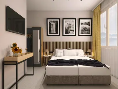 a bedroom with a bed and a flat screen tv at Hotel Etropol, Center Etropole in Etropole