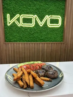 a plate of food with a burger and french fries at Hotel Etropol, Center Etropole in Etropole