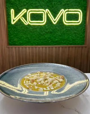 a bowl of food on a table in front of a sign at Hotel Etropol, Center Etropole in Etropole